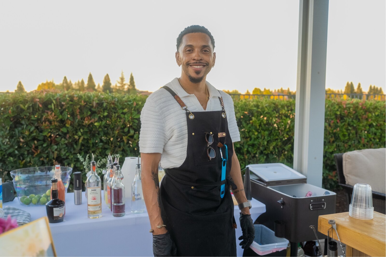 Tyler smiling behind the original 916 Pour Decisions mobile bar at an outdoor event.
